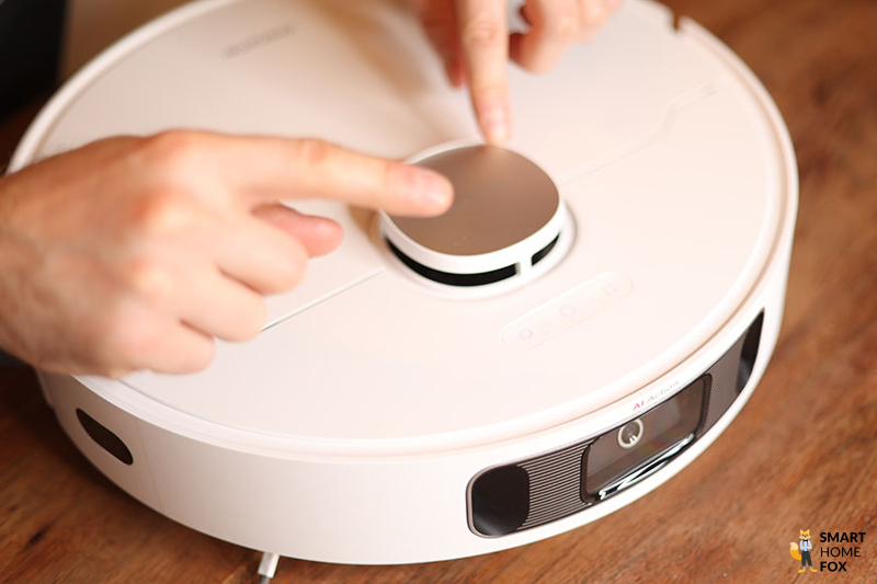 The laser navigation tower of the Dreame L10s Ultra is touched with both hands.